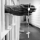 An inmate with a jail issued cross inside the segregation unit at Pitchess Honor Rancho, one of the ten different units that comprise the sprawling Los Angeles County Jail system which houses 21,000 inmates, the world's largest jail population.