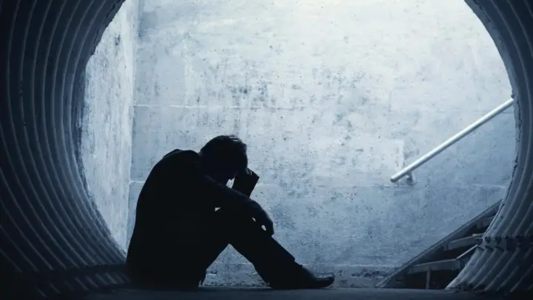 Desperate,Businessman,In,Silhouette,Lying,On,The,Ground,And,Holding