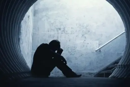 Desperate,Businessman,In,Silhouette,Lying,On,The,Ground,And,Holding