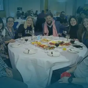 WTC celebration table smiling people - Church Leaders page