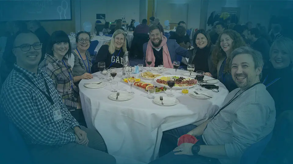 WTC celebration table smiling people - Church Leaders page