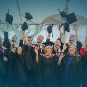 WTC Alumni image throwing flatcaps in the air